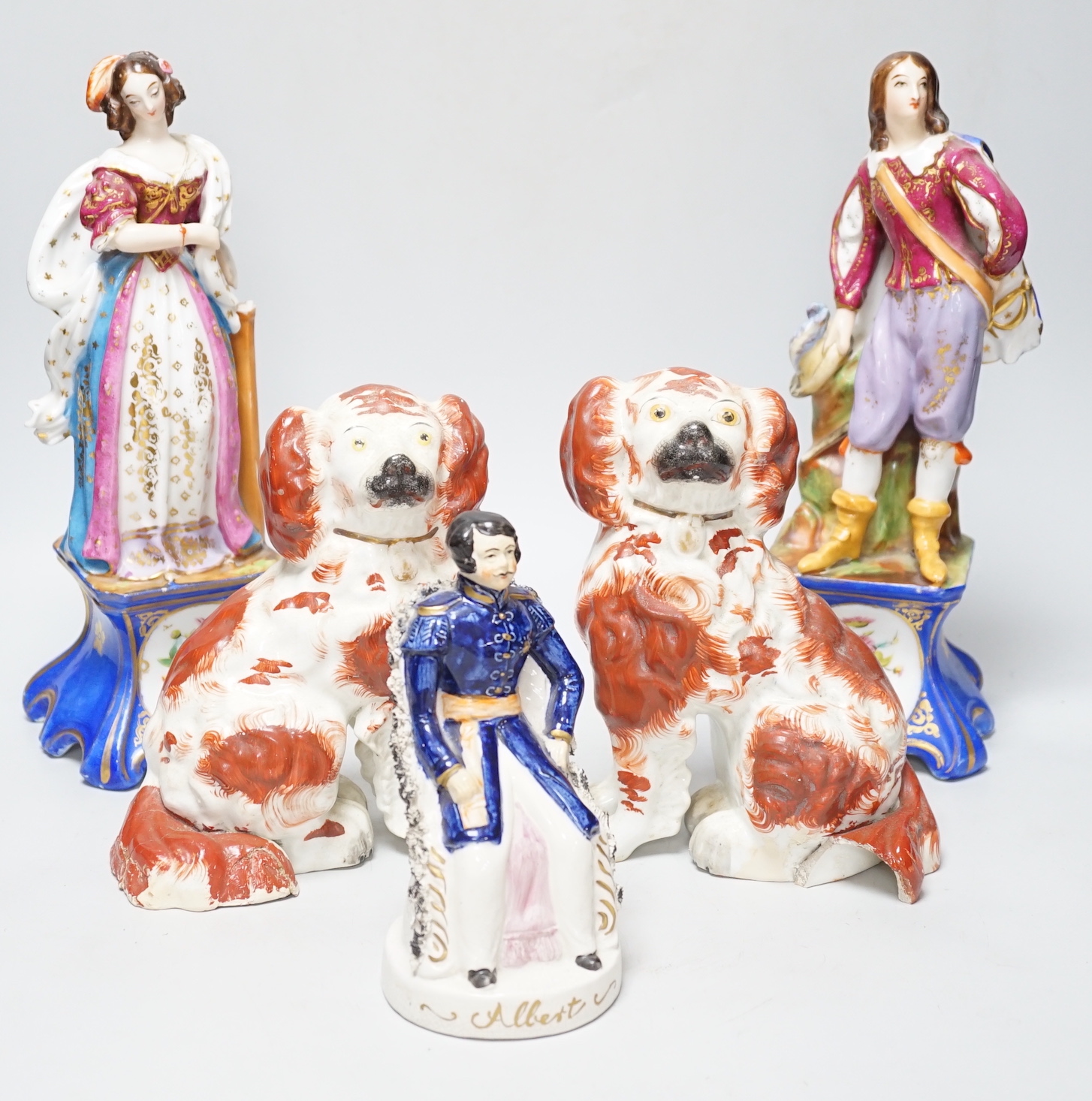 A pair of late 19th century French porcelain figures of cavalier and a maiden, a late pottery figure of Prince Albert and a pair of Staffordshire dogs (5)